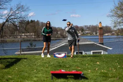 two people standing in a field flying a kite at Hilltop Lakehouse - Free Kayaks Deck PLX in Akron