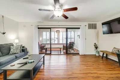 a living room with a couch and a ceiling fan at Lakefront Port Clinton Condo with Boat Dock and Slip! in Port Clinton
