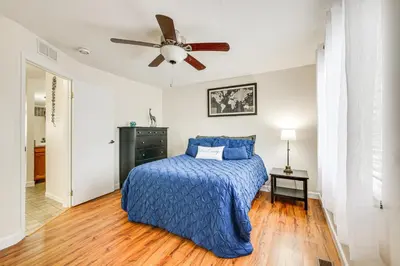 a bedroom with a bed and a ceiling fan at Lakefront Port Clinton Condo with Boat Dock and Slip! in Port Clinton