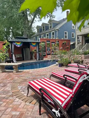 a row of benches sitting next to a pool at Mike & Allen's Place on the Park_1 in Columbus