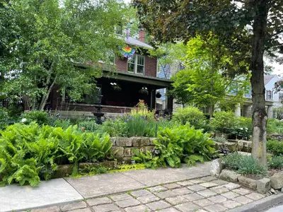 a garden in front of a house with flowers at Mike & Allen's Place on the Park_1 in Columbus