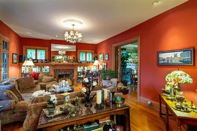 a living room with orange walls and a couch at Mike & Allen's Place on the Park_1 in Columbus