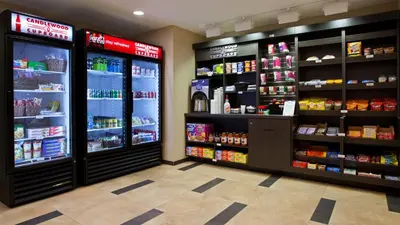 a grocery store aisle with a lot of products at Candlewood Suites Carrollton by IHG in Carrollton