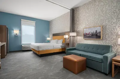 a hotel room with a bed and a couch at Home2 Suites By Hilton Cincinnati Eastgate in Cincinnati