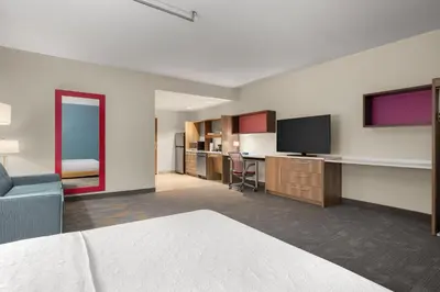 a hotel room with a bed and a flat screen tv at Home2 Suites By Hilton Cincinnati Eastgate in Cincinnati