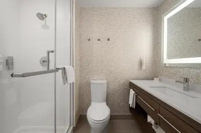a bathroom with a toilet and a sink and a mirror at Home2 Suites By Hilton Cincinnati Eastgate in Cincinnati