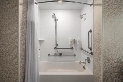 a bathroom with a tub and a shower and a bath tub at Home2 Suites By Hilton Cincinnati Eastgate in Cincinnati