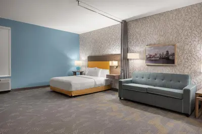 a hotel room with a bed and a couch at Home2 Suites By Hilton Cincinnati Eastgate in Cincinnati
