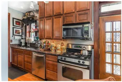 a kitchen with a stove and a microwave at Mike & Allen's Place on the Park_2 in Columbus