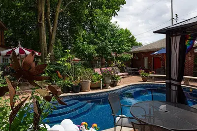 a swimming pool with a table and chairs and plants at Mike & Allen's Place on the Park_2 in Columbus