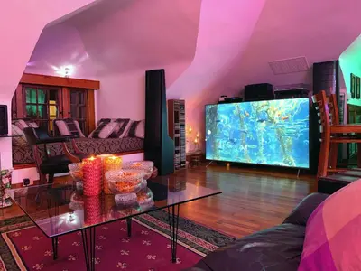 a living room with a large tv and a table at Mike & Allen's Place on the Park_2 in Columbus