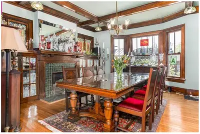 a dining room with a table and a fireplace at Mike & Allen's Place on the Park_3 in Columbus