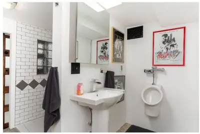 a white bathroom with a sink and a urinal at Mike & Allen's Place on the Park_3 in Columbus