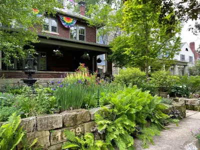 a garden in front of a house with flowers at Mike & Allen's Place on the Park_3 in Columbus