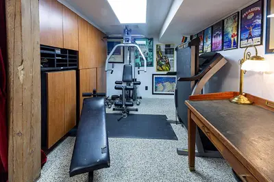 a room with a gym with a bench in it at Mike & Allen's Place on the Park_3 in Columbus