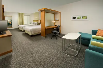 a hotel room with a bed and a couch at SpringHill Suites by Marriott Bridgeport Clarksburg in Bridgeport