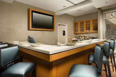 a bar in a restaurant with a tv on the wall at SpringHill Suites by Marriott Bridgeport Clarksburg in Bridgeport