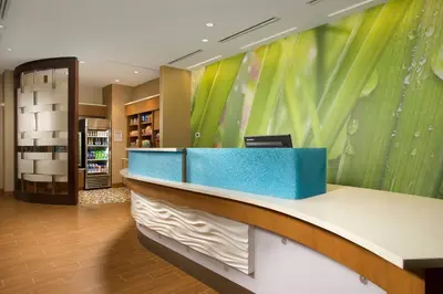 a lobby with a blue and white reception desk at SpringHill Suites by Marriott Bridgeport Clarksburg in Bridgeport