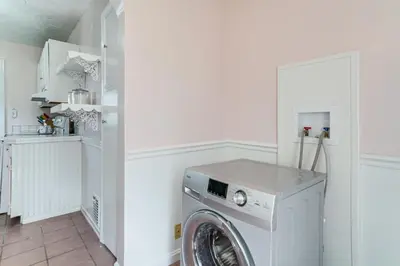 a white laundry room with a washer and dryer at Coastal Lake Erie Cottage with Amazing Water Views! in Euclid