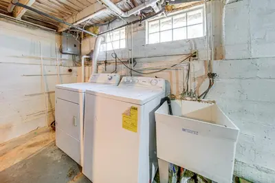 a white washer and dryer in a room at Coastal Lake Erie Cottage with Amazing Water Views! in Euclid