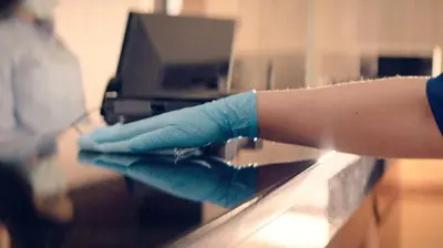 a person with blue gloves on a counter at ECONO LODGE in Erlanger