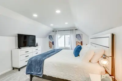 a bedroom with a large bed with a tv on it at The Maple Tree Home 14 Mi to Downtown Cleveland in Maple Heights