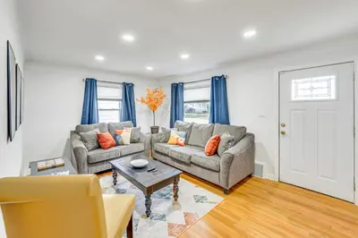 a living room with two couches and a table at The Maple Tree Home 14 Mi to Downtown Cleveland in Maple Heights