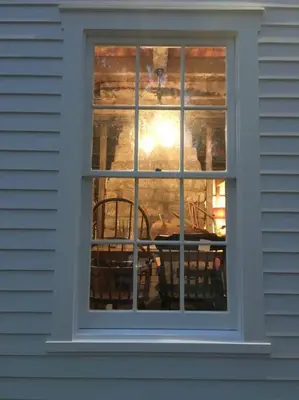 a window of a house with a table and a chair at Historic Farmhouse by Nature Preserve in Charleston