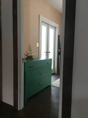 a room with a green dresser with a christmas tree on it at Historic Farmhouse by Nature Preserve in Charleston