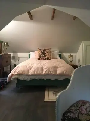 a bedroom with a bed with a pillow on it at Historic Farmhouse by Nature Preserve in Charleston