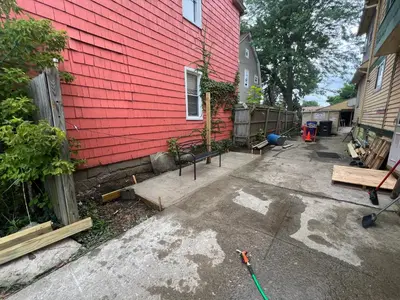 a red house with a driveway in front of it at Stay with Jay - Quinta Suite in Cleveland