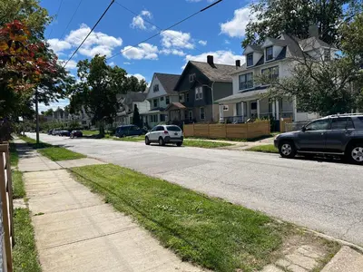 a street with cars parked in front of houses at Stay with Jay - Quinta Suite in Cleveland
