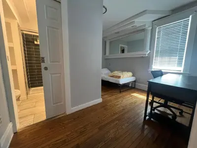a room with a desk and a room with a bed at Stay with Jay - Quinta Suite in Cleveland