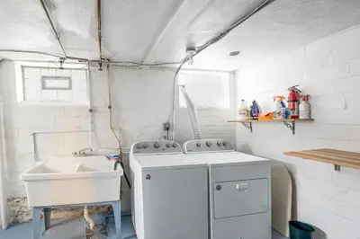 a kitchen with a sink and a washing machine at WFH-Friendly Abode with Home Gym in Cleveland in Cleveland