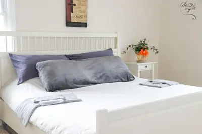 a white bed with two towels on top of it at Creation Resorts in Williamstown