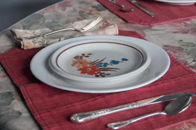 a plate with a flower design on it sitting on a table at Creation Resorts in Williamstown