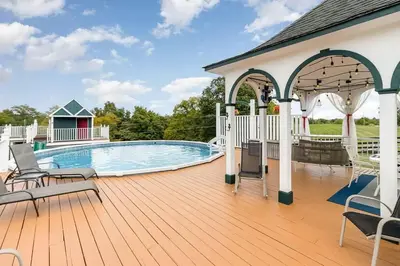 a deck with a swimming pool and a pavilion at Creation Resorts in Williamstown