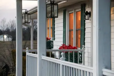 a house with a white railing and a window at Creation Resorts in Williamstown