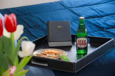 a tray with a bottle of beer and a tray of food at Creation Resorts in Williamstown