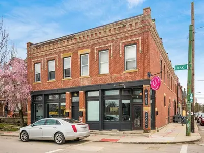 a car parked in front of a brick building at Modern Apartment with Pool Table! Pet-friendly! in Columbus
