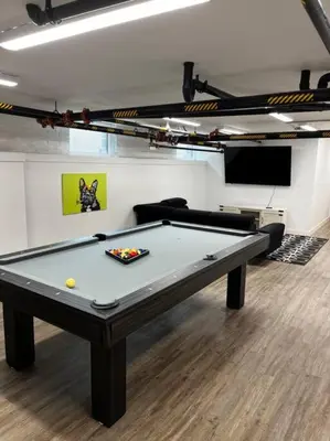 a pool table in a room with a couch and a table at Modern Apartment with Pool Table! Pet-friendly! in Columbus