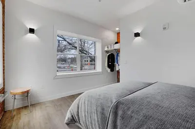 a white bedroom with a bed and a window at Modern Apartment with Pool Table! Pet-friendly! in Columbus