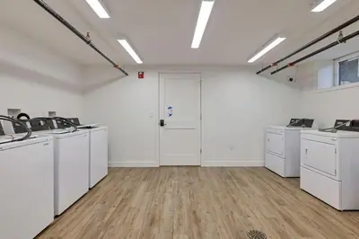 a large white room with sinks and washing machines at Central Loft with Pool Table! Pet-friendly Haven! in Columbus