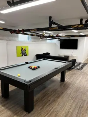 a pool table in a room with a couch at Central Loft with Pool Table! Pet-friendly Haven! in Columbus