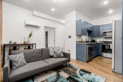 a living room with a couch and a kitchen at Designer 1-Bed Haven near Downtown! Pets Welcome! in Columbus