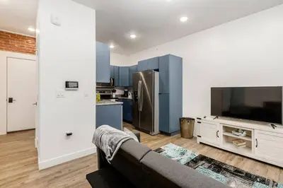 a living room with a couch and a large television at Designer 1-Bed Haven near Downtown! Pets Welcome! in Columbus