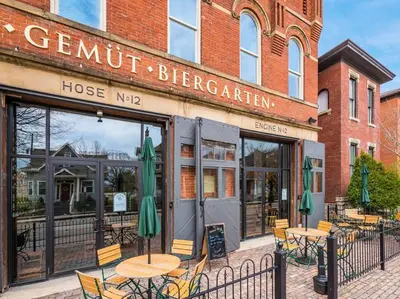 a restaurant with tables and chairs in front of a building at Designer 1-Bed Haven near Downtown! Pets Welcome! in Columbus