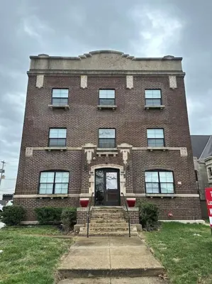 a large brick building with a front door and stairs at Trendy Loft Escape with Pool Table Bring Your Pets in Columbus