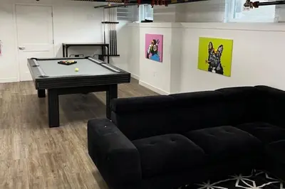 a living room with a pool table and a couch at Trendy Loft Escape with Pool Table Bring Your Pets in Columbus