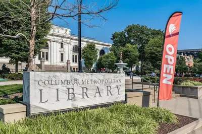 a sign for a library in front of a building at Oasis with Pool Table! Stylish Stay, Pets Allowed! in Columbus
